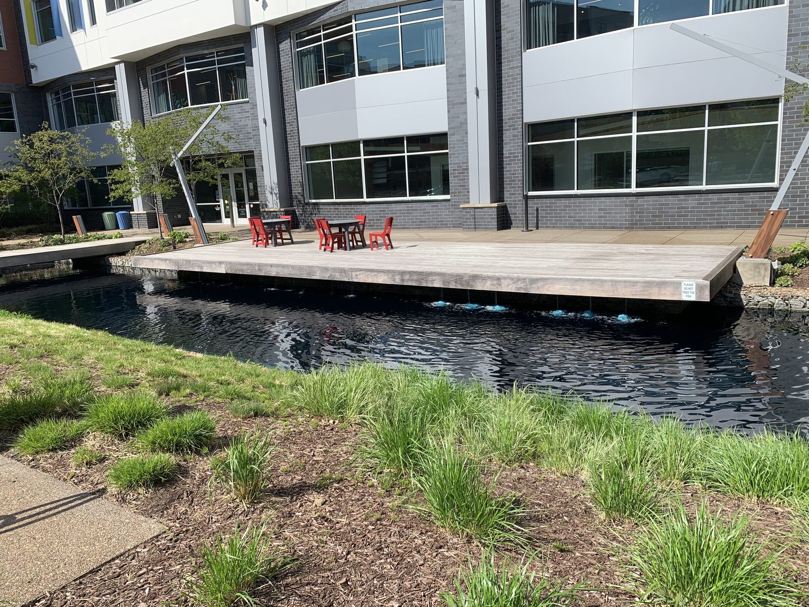 The courtyard at 6425 Living Place — Bakery Square — with deck seating over the koi pond and the office building entrance